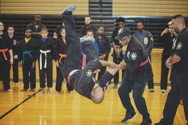 Grandmaster demonstrate technique with Sensei Melbert Lee Jr. to K-5 Students