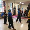 Instructor Lee Sloan working with Karate Five Students